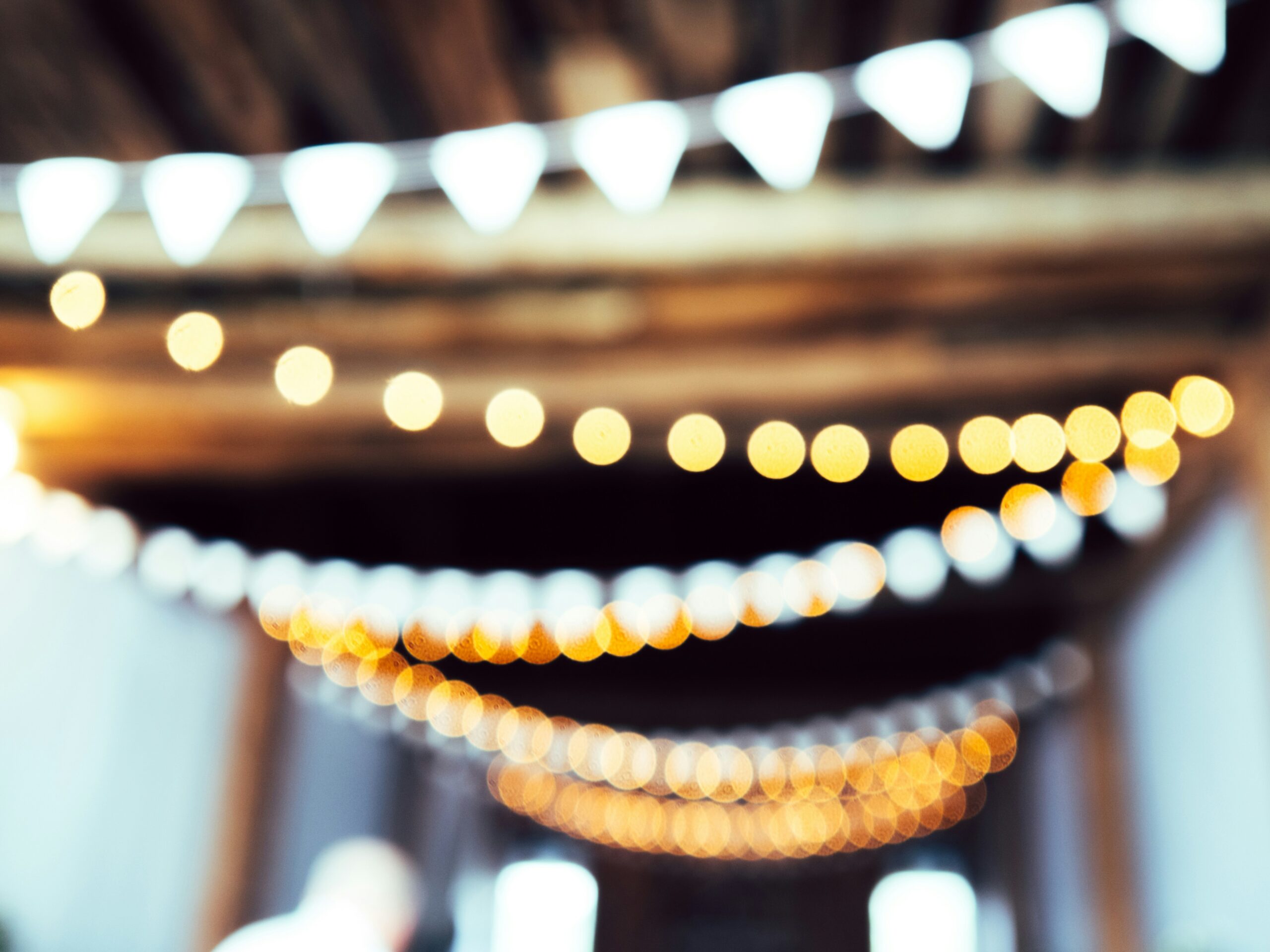 out of focus twinkle lights hang in an event venue